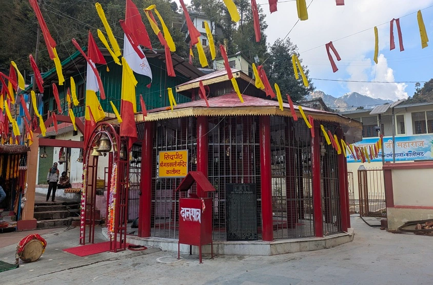 Beautiful picture of Kalimath temple decorated with flags and flowers